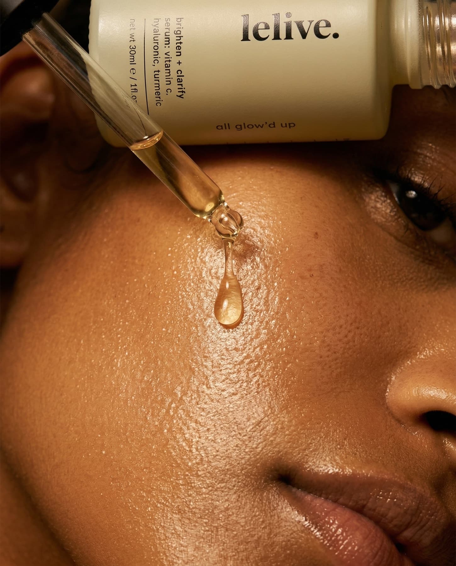 Creator-style close-up of a serum dropper releasing a drop onto bare skin, real pores and texture