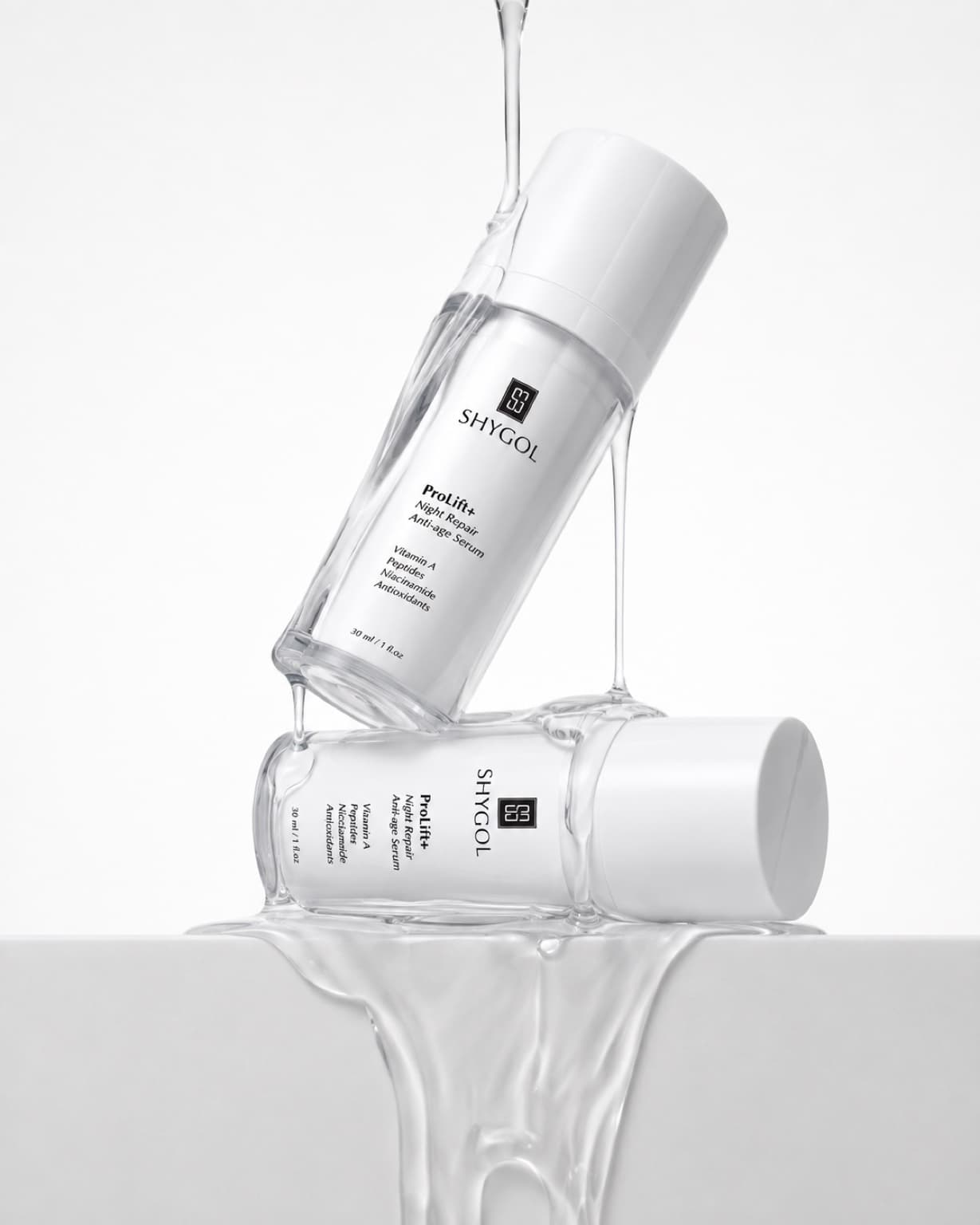 Shygol product shoot: two ProLift+ Night Repair serum bottles stacked and dripping with water